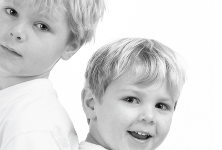 two boys standing back to back